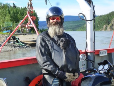 biker-and-his-dog-on-the-river-ferry-to-dawson-city-from-the-top-of-the-world-highway